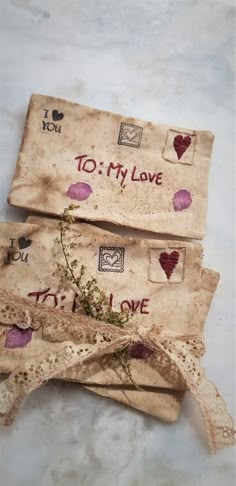 two envelopes that have been decorated with hearts and i love you written on them