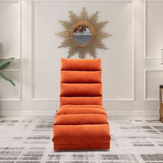 an orange reclining chair sitting on top of a rug