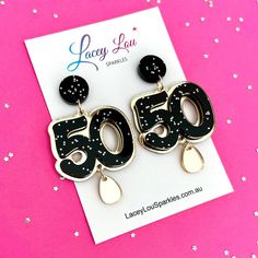 Celebrate your 50th birthday in style with our sparkly fifty earrings. Featuring a double layered acrylic, including our Strawberry Confetti glitter. These fun birthday earrings will set the mood for your big event. Buying as a gift? Add a sparkly pouch or earring gift box at checkout! MEASUREMENTS: 48mm long  62mm long (with teardrop) MATERIALS: Laser cut acrylic Surgical steel studs Personalized Black Jewelry For Party, Black Glitter Jewelry For Party, Birthday Earrings, Earring Storage, Wholesale Gifts, Earring Gift, Laser Cut Acrylic, Red Shop, Acrylic Earrings