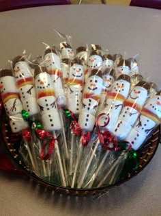 a bowl filled with marshmallows covered in frosty snowman candies