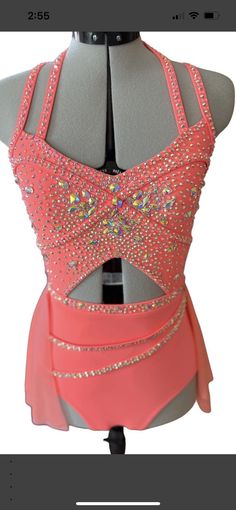 the back of a woman's dress with sequins and beads on it