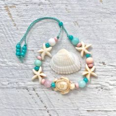 a seashell and starfish bracelet with beads