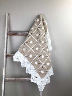 The granny square pattern adds a touch of nostalgia to this modern baby blanket, making it a perfect gift for any new parents. The soft and warm acrylic material ensures that the baby will stay snug and comfortable. The neutral white and parchment colors make it versatile and easy to incorporate into any nursery theme. Plus, the pretty border adds a charming and elegant touch to the overall design. Made from 100% premium acrylic makes this blanket of our essentials collection easy care. The elementals collection offers a range of blankets made from acrylic blend yarns making them durable and long lasting for everyday use. Their low maintenance qualities make them a practical choice for those seeking a reliable and versatile blanket. With this collection you can enjoy the comfort and warmth Modern Granny Square Blanket, Farmhouse Granny Square, Vintage Crochet Baby Blanket, Motifs Granny Square, Blanket Making, Crochet Blanket Tutorial, Modern Baby Blanket, Blanket Tutorial, Crocheted Baby Blanket