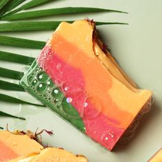 a soap bar sitting on top of a table next to a palm leaf and other items