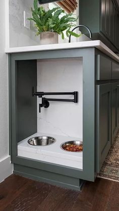 a dog bowl in the corner of a kitchen