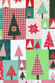 a patchwork christmas quilt with trees on it