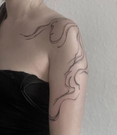 a woman's arm with a tattoo on it that is shaped like a horse