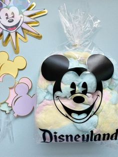 there is a mickey mouse cake in the bag and some decorations on the wall behind it