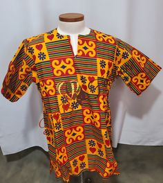 Round Neck Dashiki shirt Short Sleeves Tailored Dashiki shirt made with very Quality Dashiki Fabric.  Ready To Ship CARE INSTRUCTIONS:  Dry Clean Recommended DO NOT BLEACH Press with warm iron on the wrong side ALL SALES ARE FINAL Traditional Fitted Kaftan With Short Sleeves, Traditional Multicolor Ankara Kaftan, Traditional Multicolor Ankara Fabric Kaftan, Red Cotton Short Sleeve Kaftan, Fitted Multicolor Short Sleeve Kaftan, Traditional Short Sleeve Batik Print Kaftan, Traditional Short Sleeve Kaftan With Batik Print, Casual Short Sleeve Batik Kaftan, Casual Short Sleeve Batik Print Kaftan