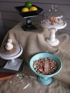 there are two trays on the table with food and wine glasses next to them