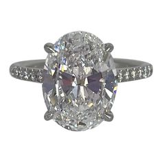 an oval cut diamond ring with pave set shoulders