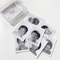 six black and white photos of children in a box with the lid open to show them