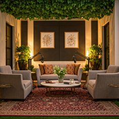 a living room filled with furniture and plants