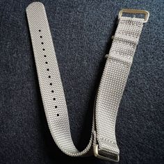 Available In 20mm Only Introducing our latest watch band innovation: our newly designed elite weave Military Inspired single single-piece watch strap. Crafted using the most comfortable materials, this all-new strap style will be our new go-to for outdoor, any-weather use. Enjoy unparalleled softness and flexibility with our premium material, meticulously selected to ensure a solid feel against your skin. The unique weave pattern design sets your watch apart, adding a touch of uniqueness to your Silver Watch Band With Bracelet Strap For Outdoor, Silver Bracelet Strap Watch Band For Outdoor, Adjustable Silver Watch Bands For Outdoor Use, Silver Adjustable Watch Bands For Everyday Use, Durable Adjustable Silver Watch Accessories, Black Experience, Latest Watches, Weave Pattern, Military Inspired