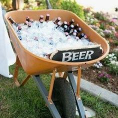 a wheelbarrow filled with bottles of beer