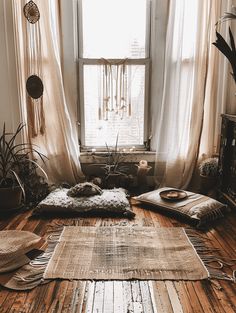 a living room filled with lots of furniture and decor on top of a wooden floor