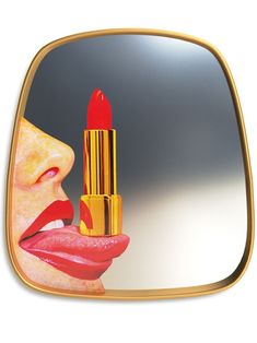 a woman holding a lipstick in front of her face with the mirror reflecting it's image