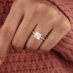 a woman's hand with a diamond ring on it