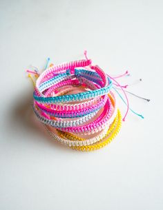 a stack of colorful bracelets sitting on top of a white table