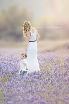 a mother and son standing in a lavender field