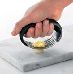 a person is grating cheese with a grater on a marble board in front of a white background