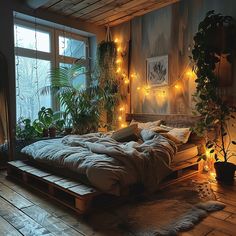 an unmade bed is surrounded by plants and lights in a room with wooden floors