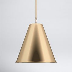 a gold pendant light hanging from a ceiling