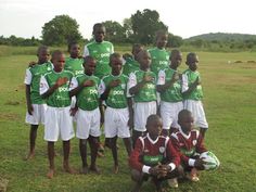 a group of young men standing next to each other on a field