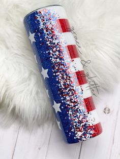 a red, white and blue fireworkstick with the american flag painted on it's side