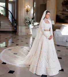 a woman in a white wedding gown and veil