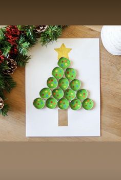 a christmas tree made out of cupcakes sitting on top of a piece of paper