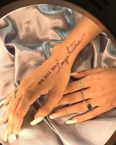 two hands holding each other with writing on them