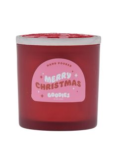 a red candle with merry christmas words on it