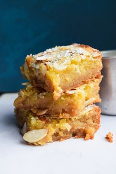 three pieces of cake sitting on top of a white counter next to a metal container