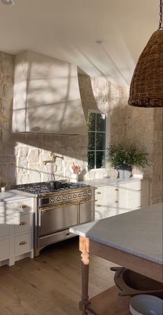 a kitchen with an oven, sink, and counter top in it's center