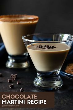 two glasses filled with dessert sitting on top of a table next to chocolate chips and nuts