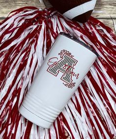 a red and white striped hula with a football on it