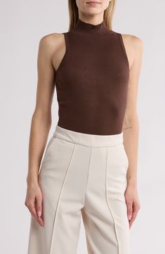 This sleeveless top in an easy, figure-hugging fit is an excellent addition to your chill-time wardrobe. Mock neck Sleeveless 75% rayon, 25% nylon Dry clean Imported High Stretch Sleeveless Tank Top For Spring, Brown Stretch Sleeveless Tank Top, Casual High Stretch Sleeveless Tank Top, Casual High Stretch Cami Tank Top, High Stretch Casual Cami Tank Top, Chic Stretch Sleeveless Sweater Vest, Brown Stretch Sleeveless Camisole, High Neck High Stretch Tank Top For Summer, Seamless Sleeveless Top For Fall