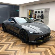 a grey sports car parked in a showroom