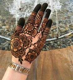 a woman's hand with henna on it