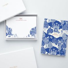 three stationery sets with blue and white designs on them, one in a box the other in a card case