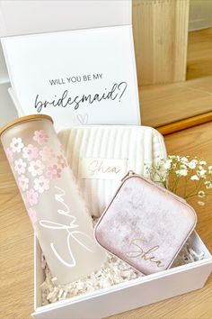 a white box with two personalized items in it and a note that says will you be my bridesmaid?