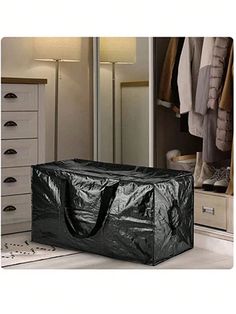 a black plastic bag sitting on top of a white floor next to a mirror and drawers