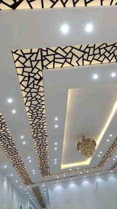 the ceiling is decorated with black and white geometric designs, along with chandeliers