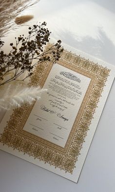 the wedding card is decorated with gold foil