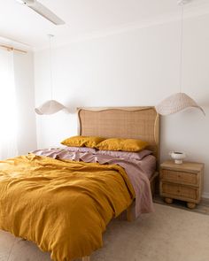 the bed is made up with yellow linens