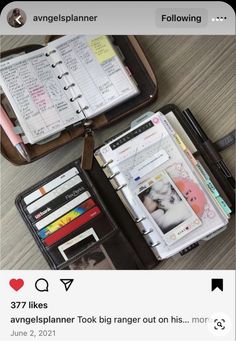 an open planner book sitting on top of a table