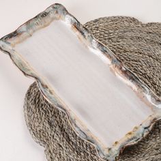 a white plate sitting on top of a woven basket