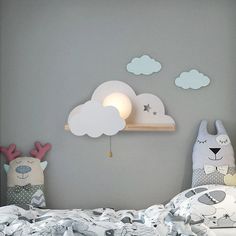 a child's bedroom with grey walls and white clouds