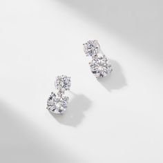 ABOUT THE PRODUCTDouble round CZ stones create an elegant drop on these modern, simple yet... Diamond Drop Earrings Simple, Bridesmaid Earrings Studs, Elegant Wedding Jewelry, Diamond Earrings Wedding, Wedding Earrings Studs, Round Diamond Earrings, Diamond Earrings Design, Silver Diamond Earrings, Jewelry Drawing